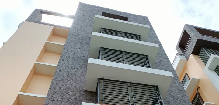 Residential facade with a dark stacked-stone cladding column