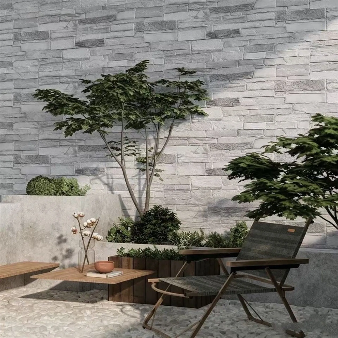 Patio with a light gray stacked flexible-stone wall, gravel, and outdoor furniture
