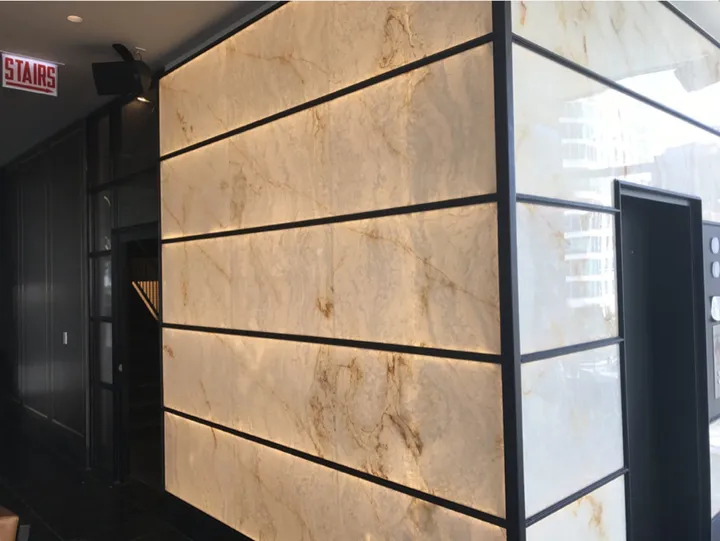 Backlit white onyx wall with gold veining