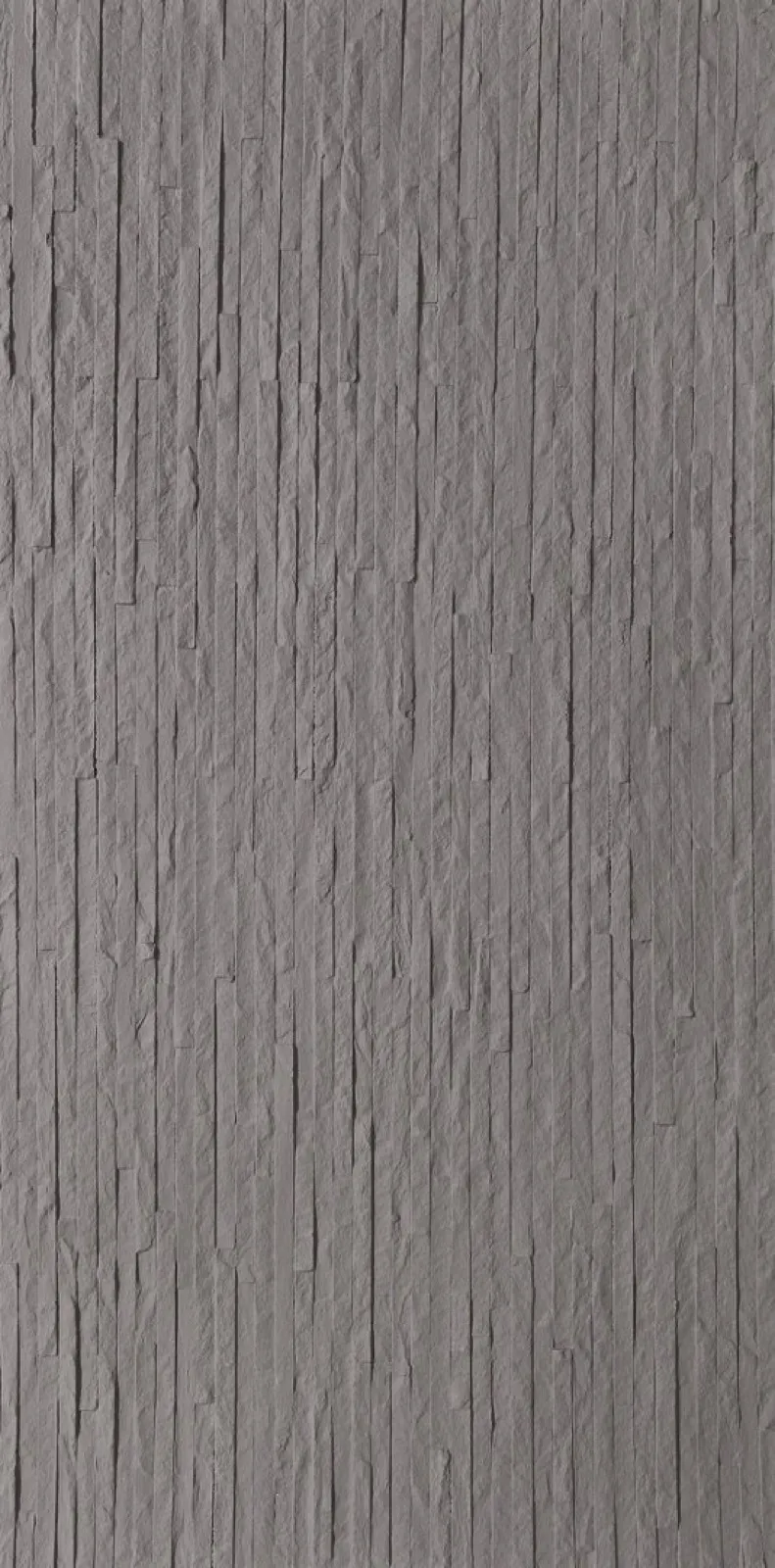 Close-up of dark gray ultra-thin stone veneer strips in a vertical stacked pattern